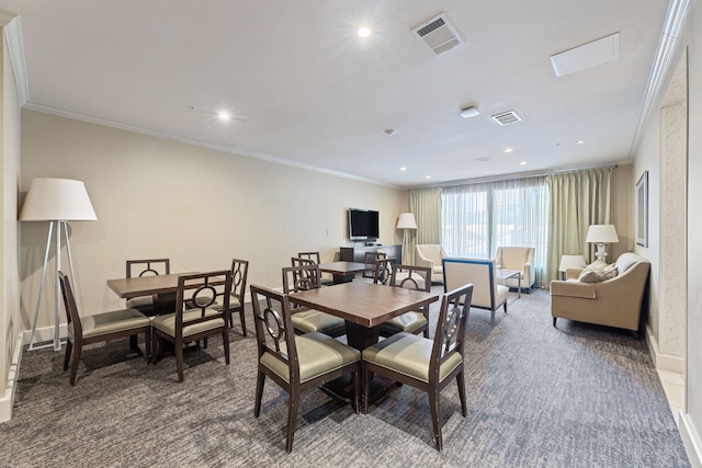 carpeted dining area with crown molding