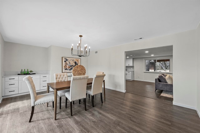 dining space with a notable chandelier and dark wood-type flooring