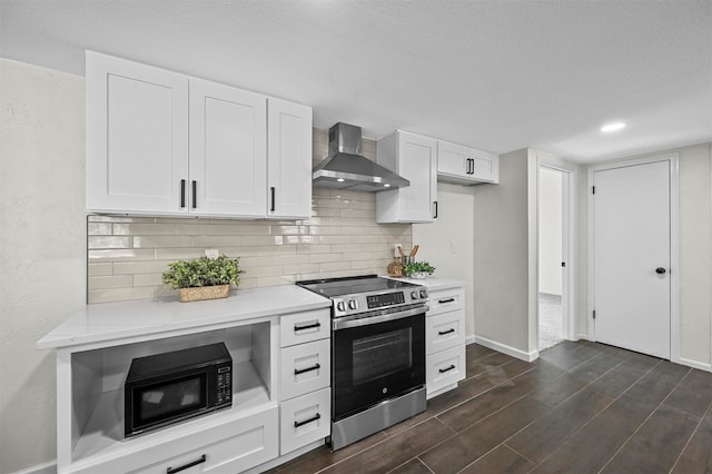 kitchen featuring white cabinets, tasteful backsplash, dark hardwood / wood-style floors, stainless steel range oven, and wall chimney exhaust hood