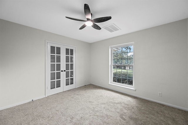 empty room featuring carpet, french doors, and ceiling fan