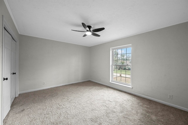 empty room with carpet flooring and ceiling fan