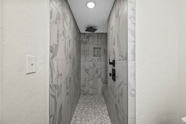 bathroom featuring tiled shower