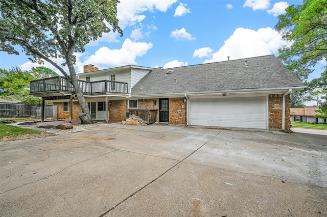 rear view of house featuring a garage