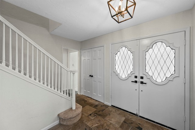 entrance foyer with a chandelier