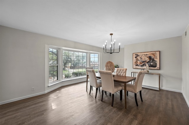 dining area with an inviting chandelier and dark hardwood / wood-style flooring