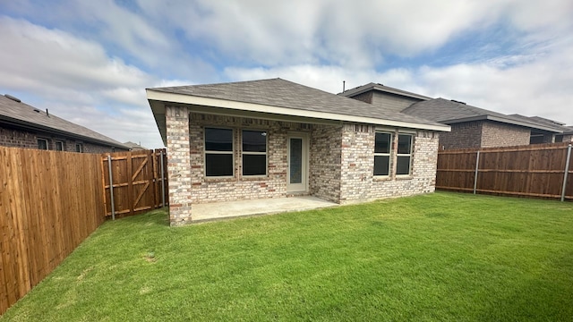 back of house featuring a yard and a patio