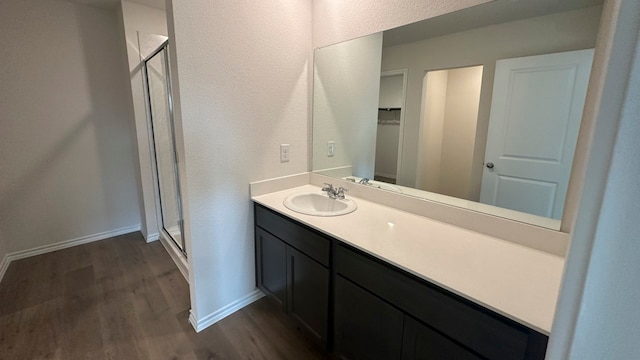 bathroom featuring vanity, hardwood / wood-style flooring, and walk in shower