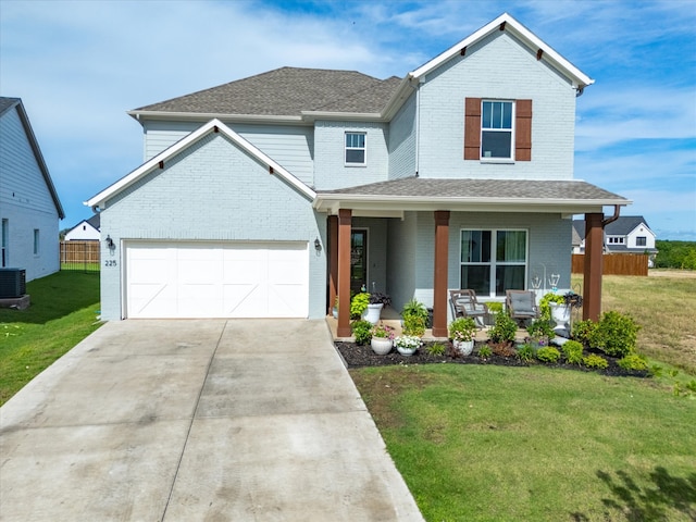 view of front of property featuring cooling unit, a garage, covered porch, and a front lawn