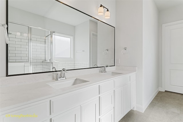 bathroom with tile patterned floors, vanity, and an enclosed shower