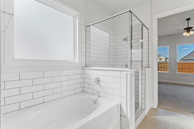 bathroom featuring tile patterned flooring, plenty of natural light, ceiling fan, and plus walk in shower