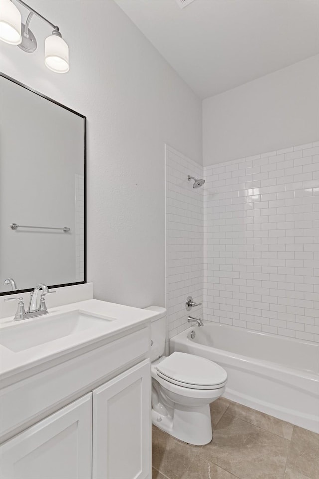 full bathroom with tile patterned flooring, tiled shower / bath combo, toilet, and vanity