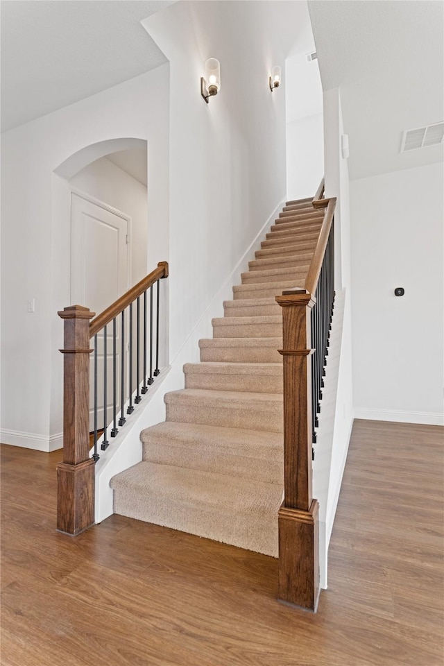 stairway with hardwood / wood-style flooring