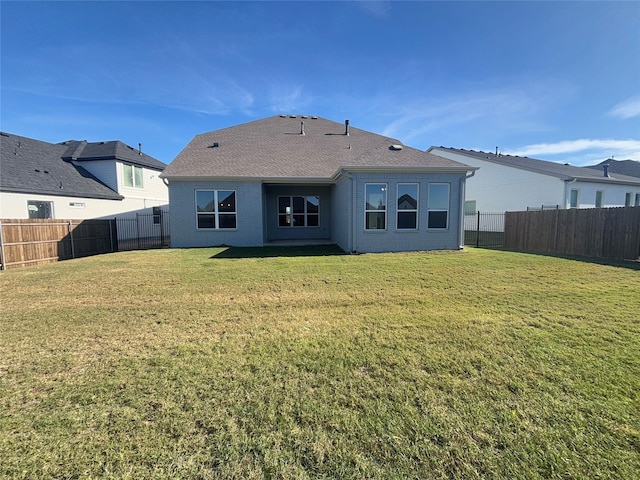 back of house with a lawn