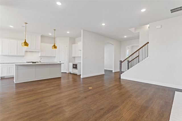 unfurnished living room with dark wood-type flooring