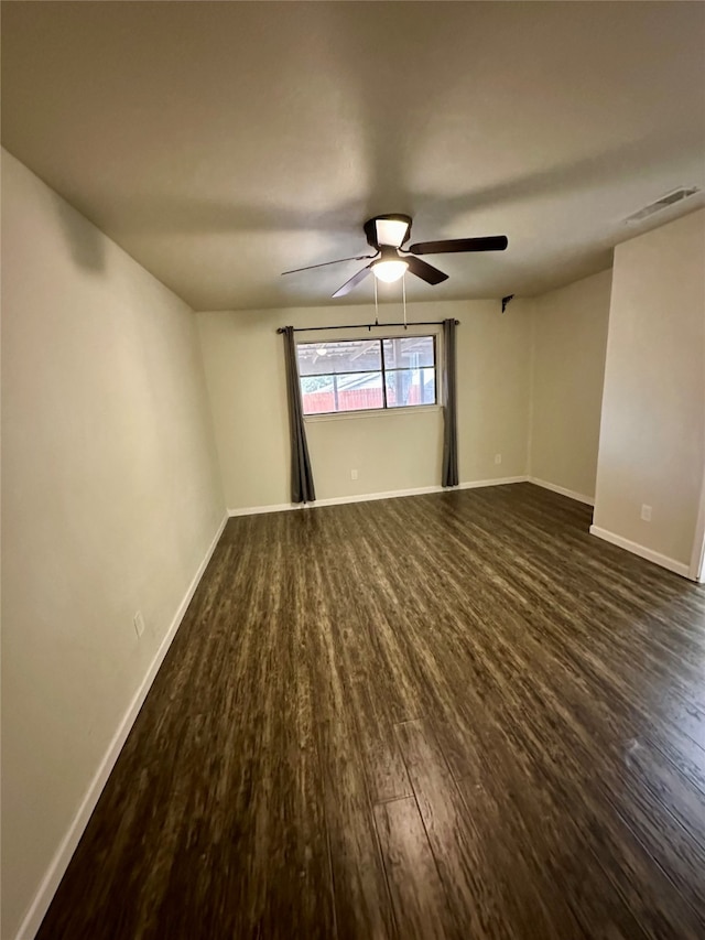 unfurnished room with ceiling fan and dark hardwood / wood-style flooring