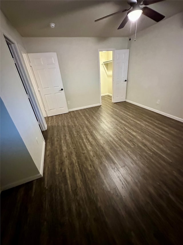 empty room with ceiling fan and dark hardwood / wood-style floors