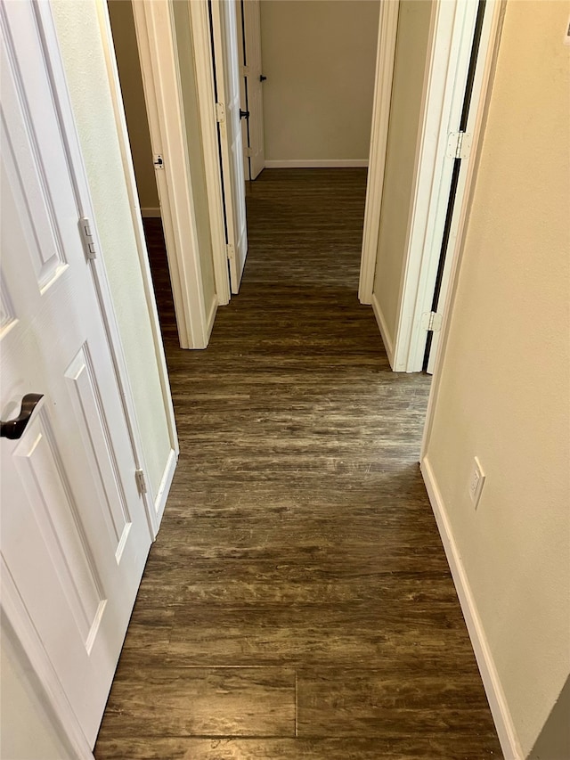 corridor with dark hardwood / wood-style floors