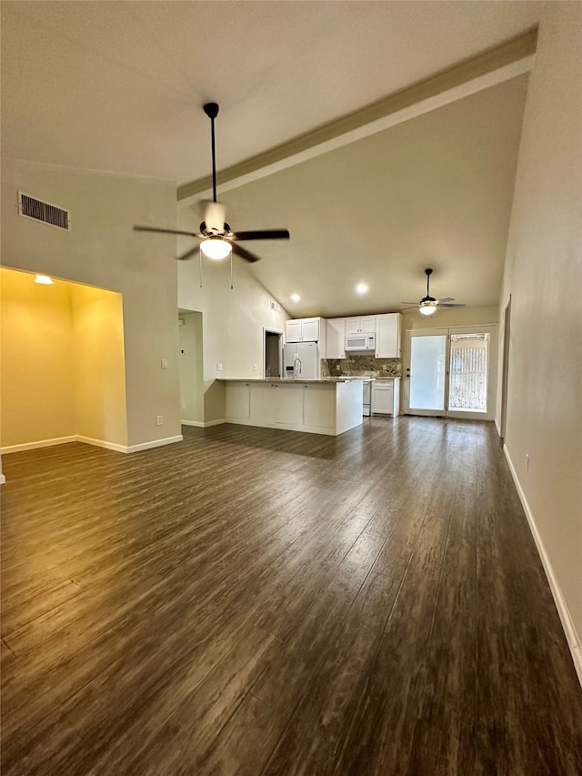 unfurnished living room featuring ceiling fan, vaulted ceiling, and dark hardwood / wood-style floors