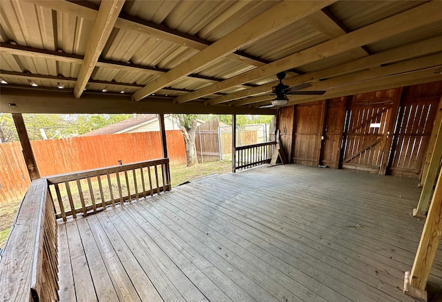 wooden deck with an outdoor structure and ceiling fan