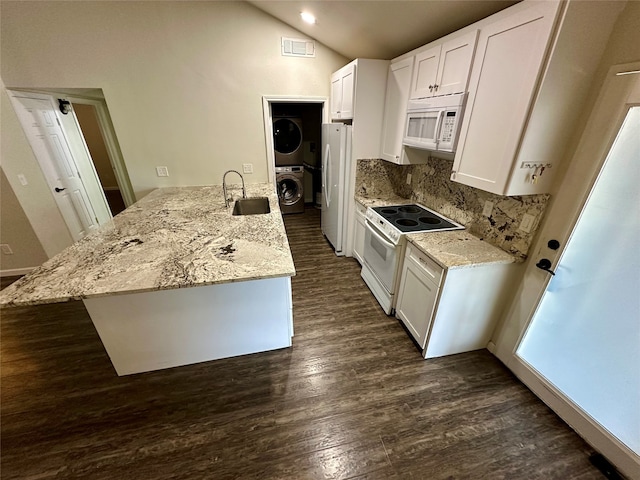 kitchen with stacked washer and dryer, dark hardwood / wood-style floors, sink, white cabinetry, and white appliances