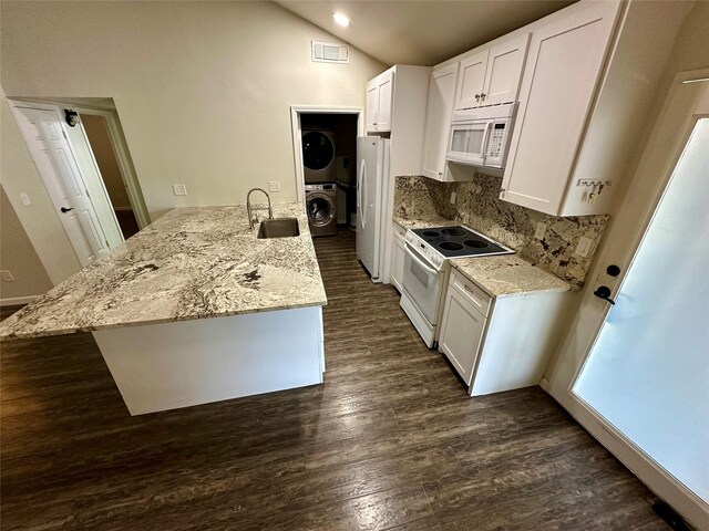 806 Mckinney Ave, Princeton, TX 75407 - kitchen featuring a sink, dark wood finished floors, stacked washing maching and dryer, and white appliances