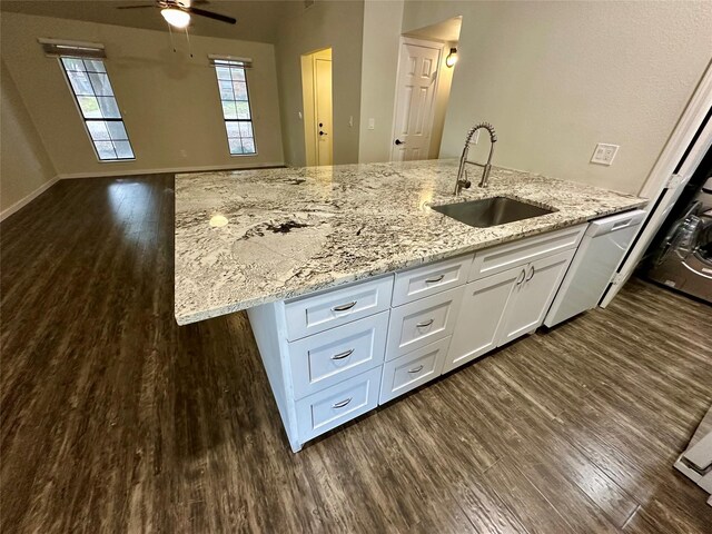 806 Mckinney Ave, Princeton, TX 75407 - kitchen with white cabinets, dark wood-style flooring, a sink, a ceiling fan, and open floor plan