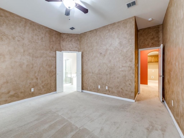 carpeted spare room with ceiling fan