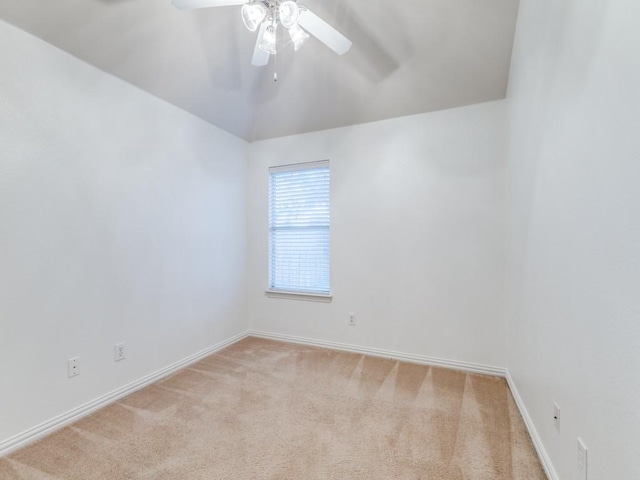 unfurnished room featuring baseboards, a ceiling fan, and light carpet