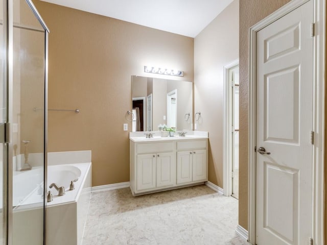 bathroom with double vanity, a garden tub, an enclosed shower, and a sink