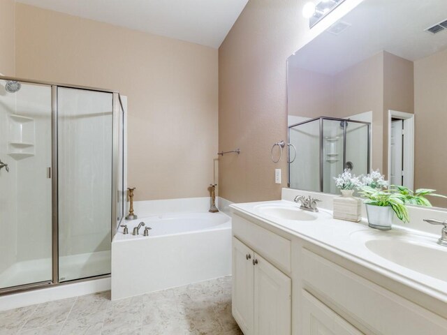 bathroom with vanity and separate shower and tub