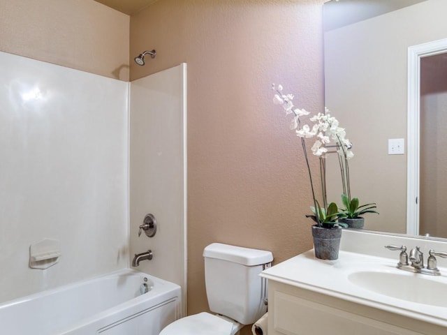 bathroom featuring toilet, shower / bath combination, a textured wall, and vanity