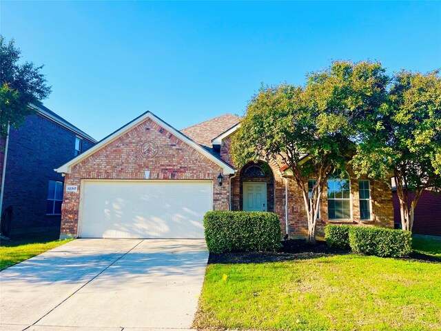 view of front of property featuring a garage and a front lawn