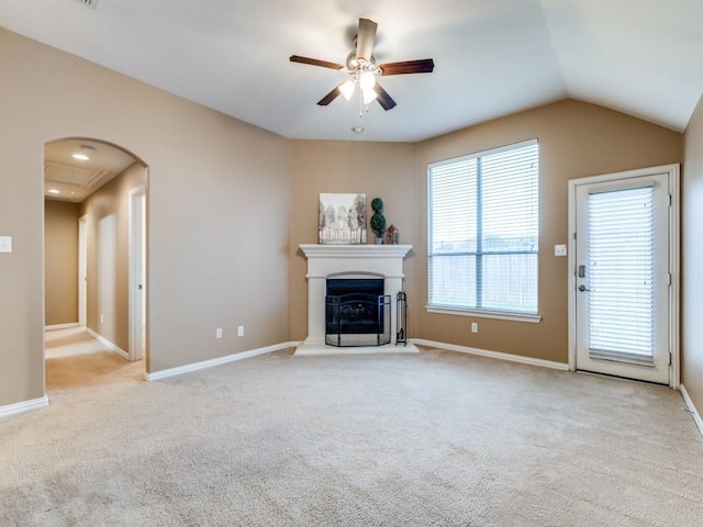 unfurnished living room featuring ceiling fan, light colored carpet, and lofted ceiling