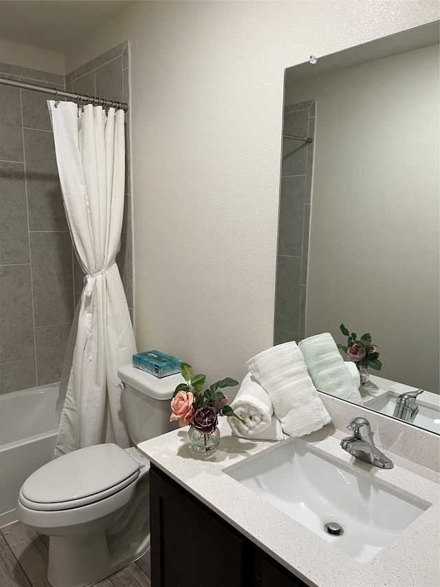 full bathroom featuring shower / tub combo with curtain, vanity, hardwood / wood-style flooring, and toilet