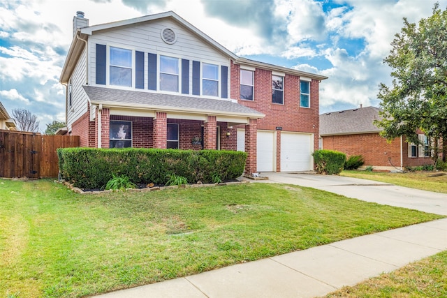 view of front of home with a garage and a front lawn