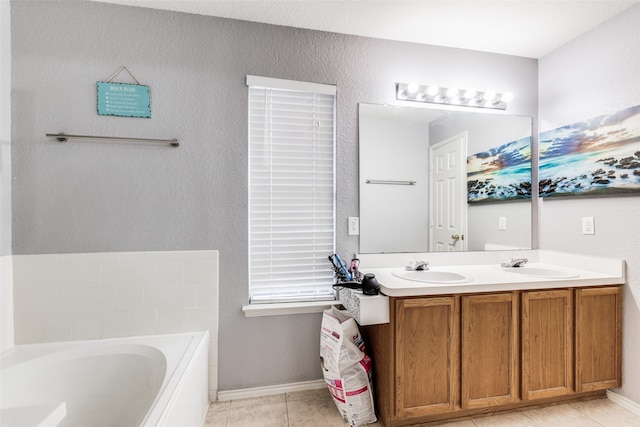 bathroom featuring vanity, tile patterned flooring, and a washtub