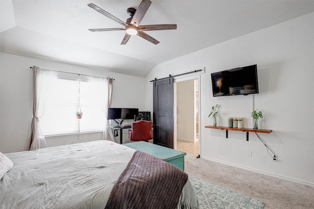 bedroom with a barn door, ceiling fan, carpet, and lofted ceiling