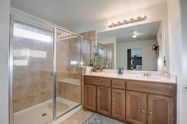 bathroom featuring tile patterned floors, vanity, and walk in shower