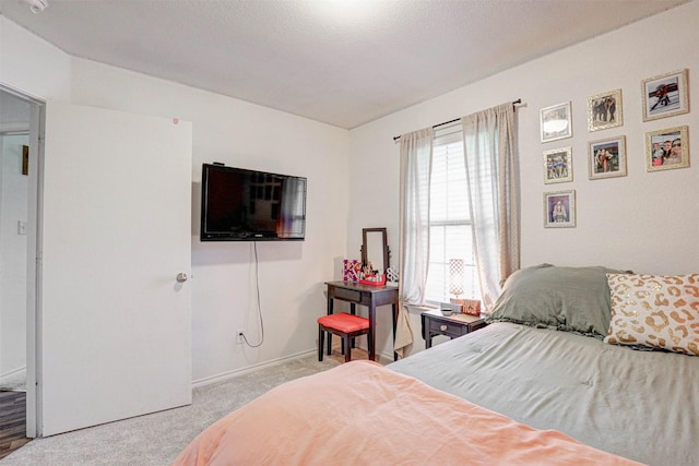 bedroom with light colored carpet