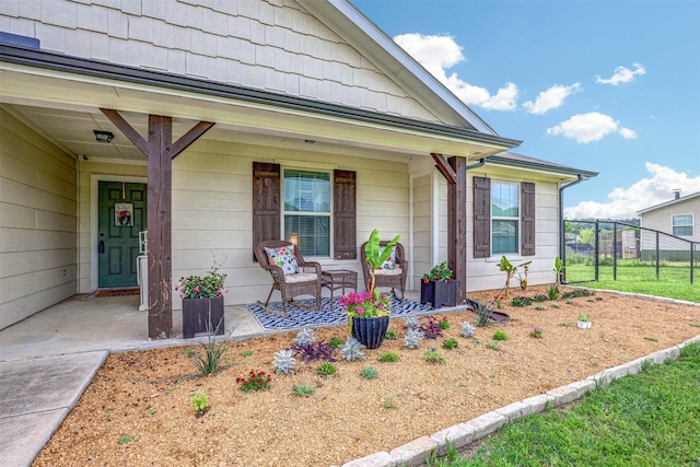 entrance to property featuring covered porch