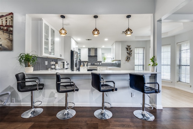 kitchen featuring stainless steel appliances, white cabinets, and kitchen peninsula