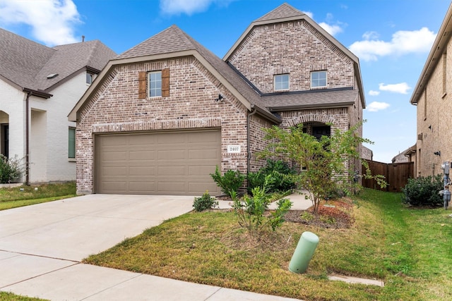 view of front of house featuring a front yard and a garage