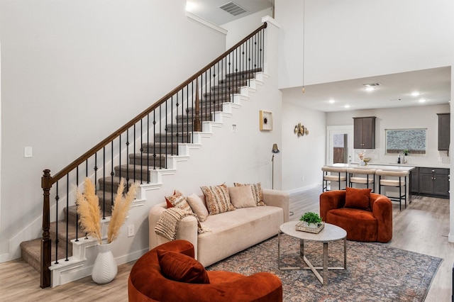 living room featuring light hardwood / wood-style flooring and sink