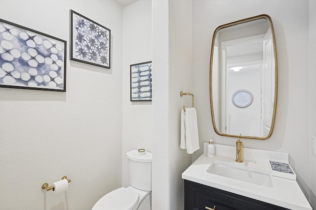 bathroom with toilet and vanity