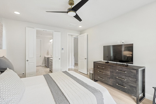 bedroom featuring ensuite bathroom, light hardwood / wood-style floors, and ceiling fan