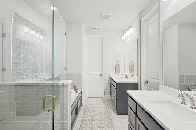 bathroom with tile patterned flooring, vanity, and independent shower and bath