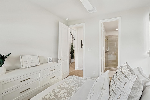 bedroom with ensuite bathroom, ceiling fan, and light hardwood / wood-style floors