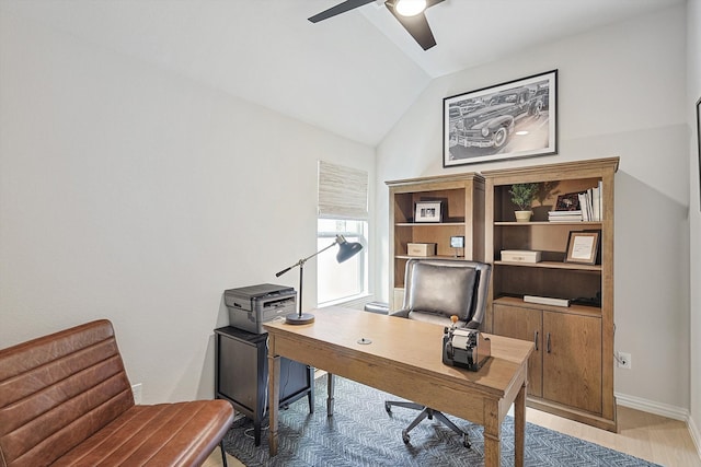 office with light wood-type flooring, ceiling fan, and vaulted ceiling