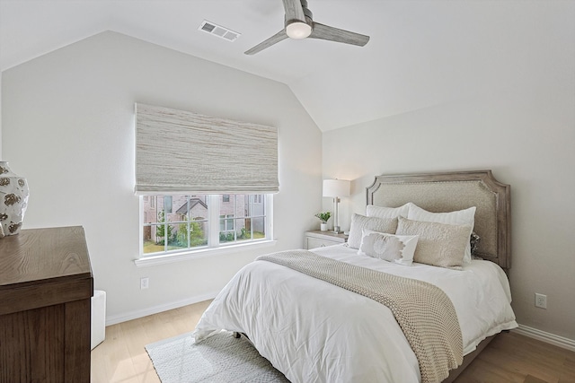 bedroom featuring lofted ceiling, ceiling fan, and light hardwood / wood-style flooring