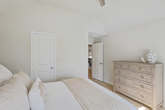 bedroom featuring light hardwood / wood-style flooring, lofted ceiling, and ceiling fan